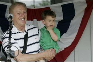 Eddie Boggs with his grandson, Landon Garcia, at Sylvania s 175th birthday celebration at the Sylvania Historical Village, where Boggs recently performed.
