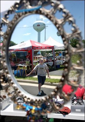 Slug: CTY cherryfest15p        Date: 6/14/2008             The Blade/Amy E. Voigt       Location: Whitehouse, Ohio  CAPTION:  Jackie Barringer, from Delta, is reflected in a mirror as she runs toward a sunglasses booth to meet a friend at the Whitehouse Cherry Festival on June 14, 2008 in Whitehouse.