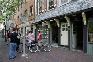 Nicholas Paddock, a gallery owner in Cincinnati, talks with David Ginsburg of Downtown Cincinnati Inc. and two residents.