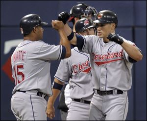 Cleveland's Grady Sizemore, right, is congratulated by Andy Marte, left, and Kelly Shoppach after hitting a three-run home run in the second inning. It was his 22nd homer of the season.