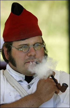 D.J. Tripp of Fort Madison, Iowa, enjoys his pipe. He and his group traveled almost 500 miles to get to Perrysburg.