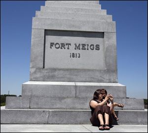 Kristin Newby of Toledo snaps a photograph of her daughter Joss Newby, 2, using a landmark as a backdrop, during activities at the Fort Meigs 1813 Independence celebration.