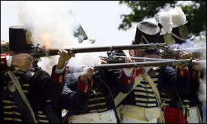 Re-enactors with Cushing's Company, 2nd Regiment fire for 'civilians' at the 1813 Independence Celebration at Fort Meigs. 