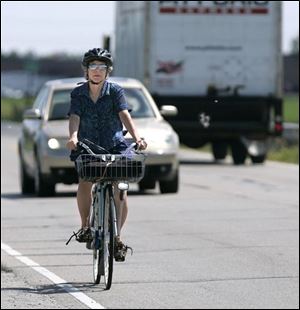 Sarah Abts rides from work with her briefcase in her basket.