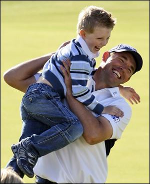 Padraig Harrington celebrates with his son, Patrick, after winning the British Open Sunday at Royal Birkdale.