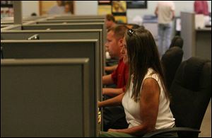 Sharon Morris, foreground, and Keith Ramm fill out online emploment applications at The Source.
