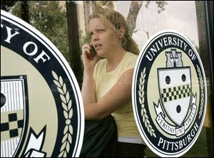 Sara Loughran, a 24-year-old
University of Pittsburgh graduate
student, uses a cell phone on campus. 