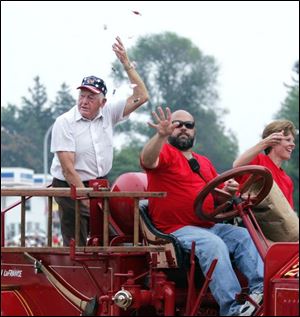 NBRN petersburg24p  07/19/2008  Blade Photo/Lori King  Reps from the Petersburg Fire Dept. throws candy from a 1922 American LaFrance during Petersburg Community Days in Petersburg, Mich.