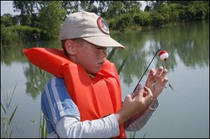 Paul Lefere, 10, of Dundee, tends to his hook.