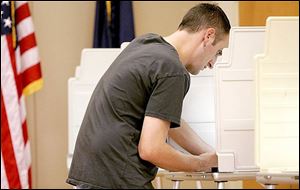 Darren Jennings, Temperance, Michigan, votes at the Bedford Township library.