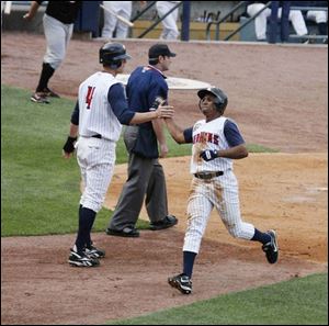 Kody Kirkland (4) greets Freddy Guzman after they had scored in the second inning.