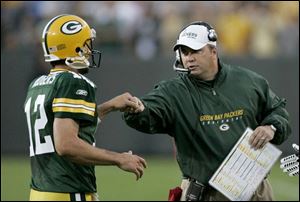 Packers' coach Mike McCarthy seems pleased with Aaron Rodgers' 9-of-15 passing for 117 yards against Cincinnati.