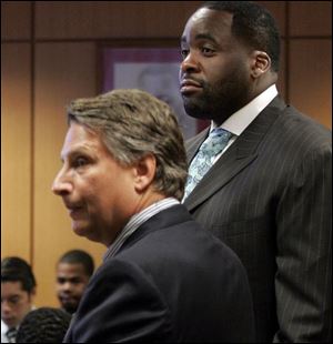 Attorney James Thomas, left, and client Kwame Kilpatrick have a topsy-turvy day in court as a judge orders Mr. Kilpatrick to be freed from his electronic tether. On appeal, another judge said the tether stays on.