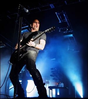 Nine Inch Nails vocalist Trent Reznor performs during a concert.