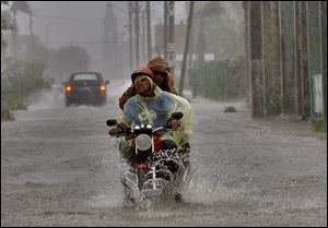 Residents make their way through a flooded street after Hurricane Ike hit the area in Camaguey, Cuba. 