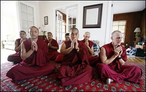 Tibetan monks from the Gaden Shartse Monastery meditate in a Maumee home where they are staying. Front
row from left are Geshe Jampa Norbu, Geshe Kelsang Gyatso, and Jang Chub Chophel. Back row from left: Lobsang
Phuntzok, Tenzin Lobsang, Lobsang Yeshe, and Lobsang Wangchuk.