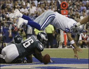 Omar Gaither looks on as Tony Romo fumbles in the end zone. Philadelphia scored on the play, but Romo got the victory.
