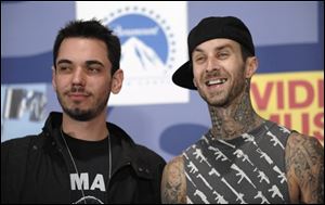 In this Sept. 7, 2008 file photo, DJ AM, left, and musician Travis Barker pose backstage at the 2008 MTV Video Music Awards held at Paramount Pictures Studio Lot in Los Angeles. A hospital spokeswoman in Columbia, S.C. says former Blink-182 drummer Barker and DJ AM, whose real name is Adam Goldstein, have been critically injured in a Learjet crash that occurred shortly before midnight on Friday, Sept. 19, 2008 in South Carolina. Federal officials say two crew members and two passengers have been killed. 