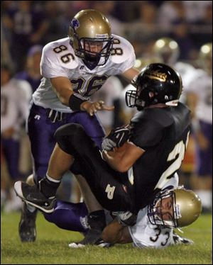 Maumee s Brian Rahman (86) and Mike Wilkins combine to bring down Perrysburg s Taylor Dimmerling last night.
<BR>
<img src=http://www.toledoblade.com/graphics/icons/photo.gif> <b>HIGH SCHOOL FOOTBALL WEEK 5:</b> View <a href=http://www.toledoblade.com/apps/pbcs.dll/gallery?Avis=TO&Dato=20080920&Kategori=SPORTS12&Lopenr=920009998&Ref=PH><b><font color=red> Maumee - Perrysburg </font color=red> </b></a> football photo gallery