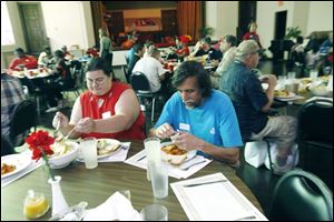 April and Stanley Page of Toledo enjoy a meal at St. Mark s Episcopal Church, where between 120 and 200 people are fed each month.