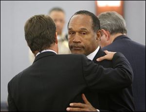 O.J. Simpson, right, with his lawyer Yale Galanter embrace after a verdict of guilty on all counts was read following his trial at the Clark County Regional Justice Center in Las Vegas on Friday, Oct. 3, 2008. The verdict comes 13 years to the day after Simpson was acquitted of murdering his ex-wife Nicole Brown Simpson and Ron Goldman. 