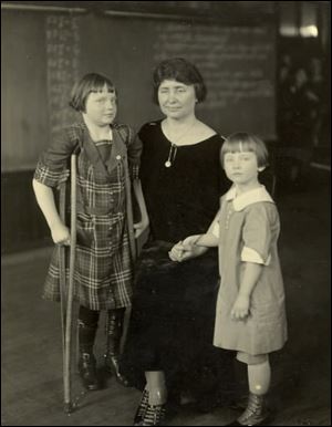 Helen Keller, center, photographed with children during
her visit to the Feilbach School for Crippled Children in Toledo in 1925.