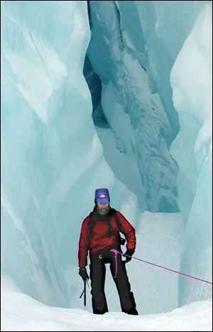 Konrad Steffen descends into an icy crevice known as a 'moulin' on the Petermann glacier in northwestern Greenland.

