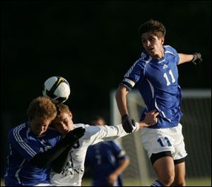 Anthony Wayne's Alex Lohse (11) watches as teammate Chris Holzer and St. John's Ian Appold try the head the ball. The Generals won easily after the teams tied 1-1 in the regular season.