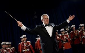 President Bush turns to the audience after conducting the United States Marine Corps Band, known as 