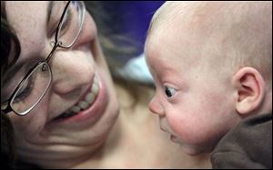 Slug: CTY nicu13p A                                        The Blade/Jeremy Wadsworth  Date: 11/012/08  Caption: Beth Vajen of Napolean, Ohio, holds her son Ethan Saneholtz, 4 months, during a reunion for  patients of the St. Vincent's Children's Hospital Newborn Intensive Care Unit (NICU) that helped mark Prematurity Awareness Day Wednesday, 11/12/08, in Toledo, Ohio. Ethan was born 12 weeks early and weighed one pound 15 ounces.