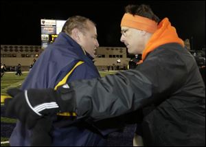 BGSU coach Gregg Brandon, right, shakes hands with UT coach Tom Amstutz after the Falcons' Friday night win. It was the last game for both coaches, as Brandon was fired yesterday.