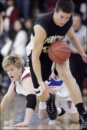 Perrysburg's David Hieber, right, pursues a loose ball given up by St. Francis' Steve Yeager Friday night. The Knights lost to the Yellow Jackets 53-52.