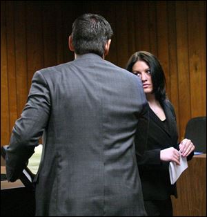 Attorney Mark Bilkovic whisks his client, former Monroe High School teacher Kelly Abdo, from the courtroom after a hearing.