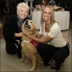 Sharon Arquette, left, and Kathleen Walczak with Goldie the dog at the 4 Paws Sake party.