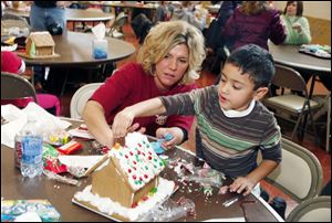 12/08/2008 The Blade/Herral Long  Caption: gingerbread house building workshop at Epworth United methodist church   Krista McCarthy  and son Case 4 1/2  of toledo work on house