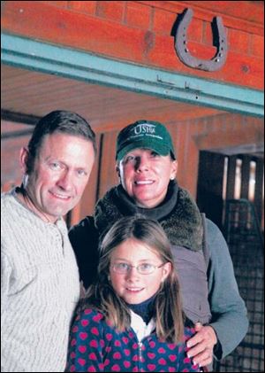 Tim and Donna Rothman with daughter Samantha. The family has a lucky horseshoe hanging over a door between their home and barn.