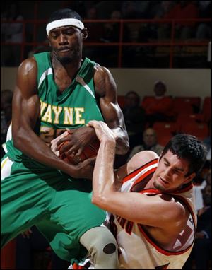 Bowling Green's Marc Larson was at the right place at the right time to battle Wayne State center Shane Lawal for the ball.