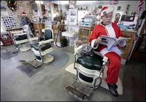 Gus Janssens waits for the next customer at the Gus and Us barbershop in Monroe. Since 1995 Mr. Janssens, 69, has dedicated the two days before Christmas to practicing his craft with a dose of holiday cheer. 