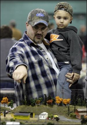 Allan Dillery and his son, Austin, 4, of Sandusky check out the miniature trains on display during the two-day Toledo Model Train Show at the Lucas County Recreation Center.