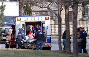 First responders load a 'victim' into an ambulance during a mock shooting drill.