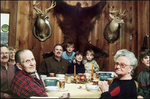 T.B. Rodabough, 91, left, and Cissy Rodabough, 90, right, get together with relatives at the family farm in Becker Bottom, Miss. He taught Mrs. Rodabough, a former Toledo-area resident, how to use a rifle and she killed a four-point buck. She had never held a gun until age 90. 