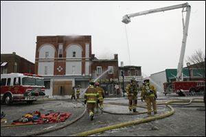 Equipment lines North Main Street, where two downtown Findlay buildings were destroyed and a third damaged by fire.