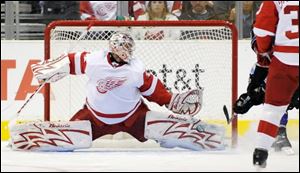 Red Wings goalie Ty Conklin stops a shot by Kings right winger Dustin Brown.