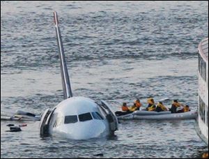 A rescue raft leaves the stricken US Airways Flight 1549 Thursday afternoon with some of the passengers plucked from the Hudson River where the plane crashed.