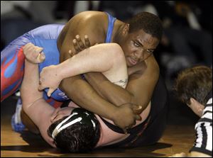 Springfield's Gary Times, who claimed the championship in the 285-pound weight class, is close to pinning Oak Harbor's Zach Sandwisch. Times was one of two Springfield champions.