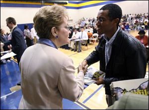 Slug: CTY NATURALIZATION29p                     Date1/29/2009           The Blade/Amy E. Voigt               Location: Toledo, Ohio  CAPTION: Ermias Gebremichael, right, a former citizen of Ethiopa, shakes hands with Marcy Kaptur, US House of Representatives, during the Naturalization Ceremony at DeVeaux Middle School on January 29, 2008.