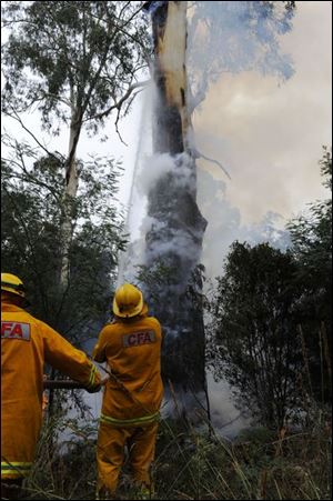 In Australia, County Fire Authority firefighters attempt to extinguish flames east of Melbourne. More than 750 houses were destroyed and 850 square miles were burned out.