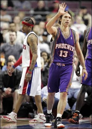 The Suns' Steve Nash celebrates a basket as the Pistons' Allen Iverson walks away last night at the Palace. Nash scored 15 points and dished out 21 assists.