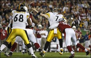 The Steelers' Ben Roethlisberger is decked by the Cardinals' Bertrand Berry during the Super Bowl. Roethlisberger says he did not have any problems despite playing with broken ribs.