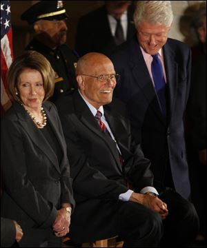 Rep. John Dingell, flanked by House Speaker Nancy Pelosi and former President Bill Clinton, basks in the attention at a reception. He is a longtime backer of the auto industry.